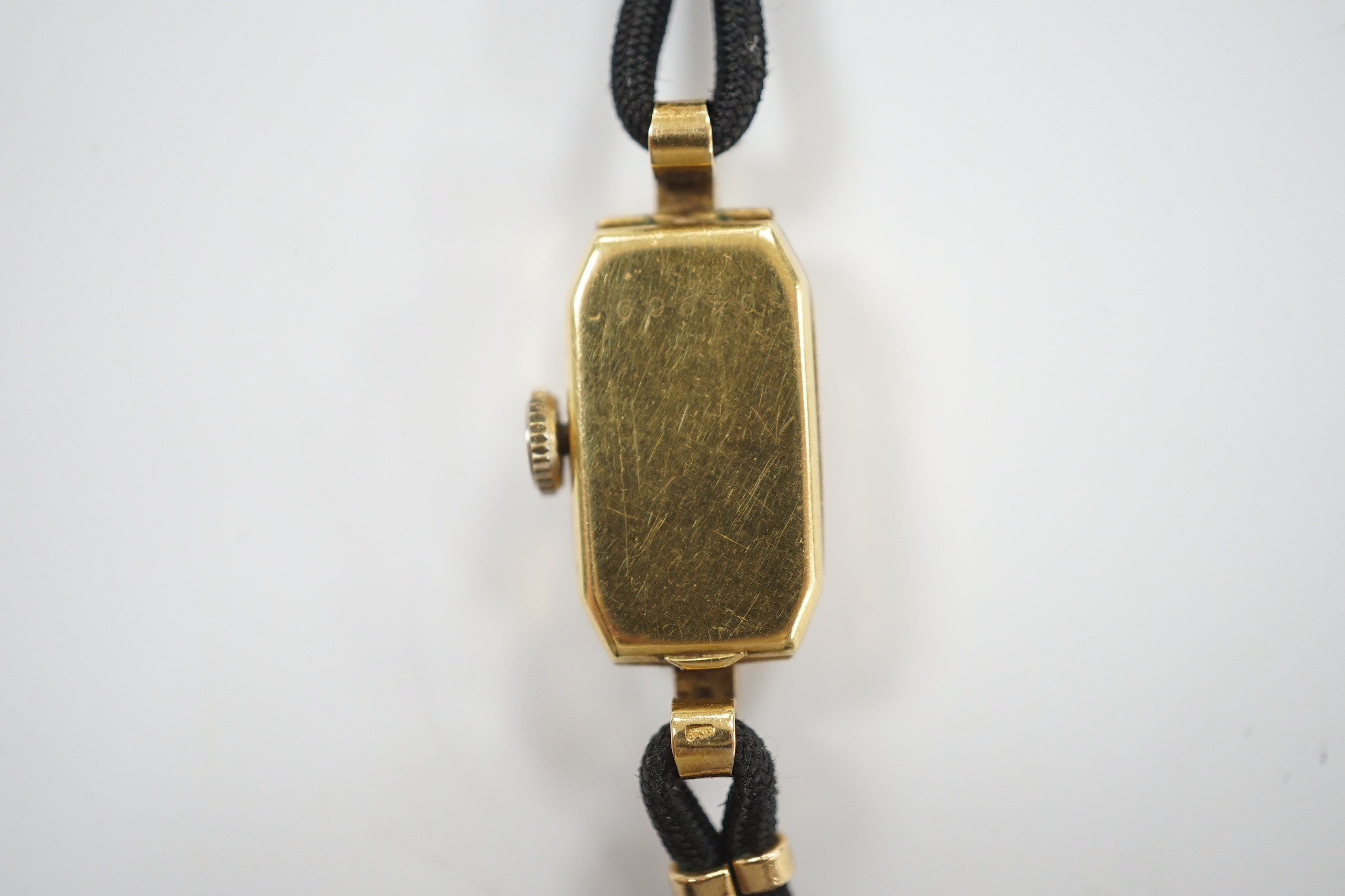 A lady's 1930's 18ct gold Eterna manual wind wrist watch, on a twin strand fabric strap with gold plated clasp